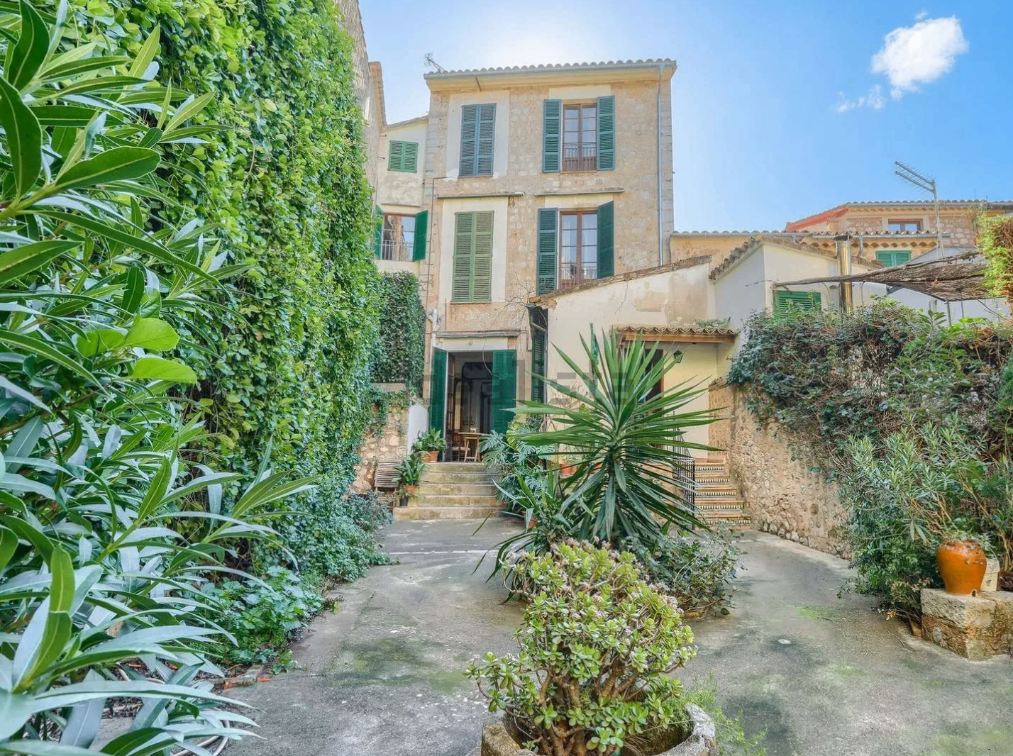 Casa Modernista — stone façade with green shutters in central Sóller